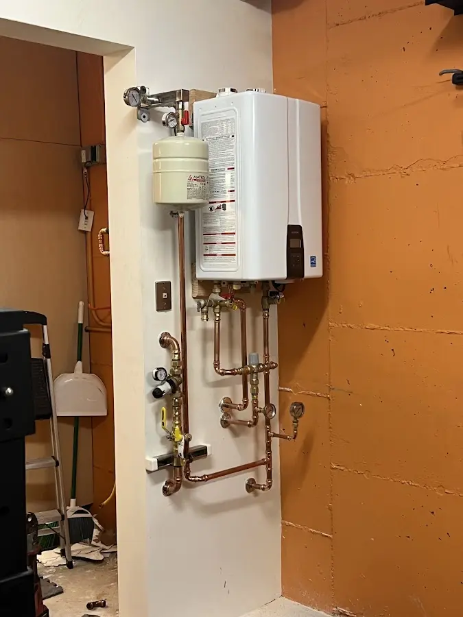 Plumbing technician inspecting water heater connections in Rowland Heights